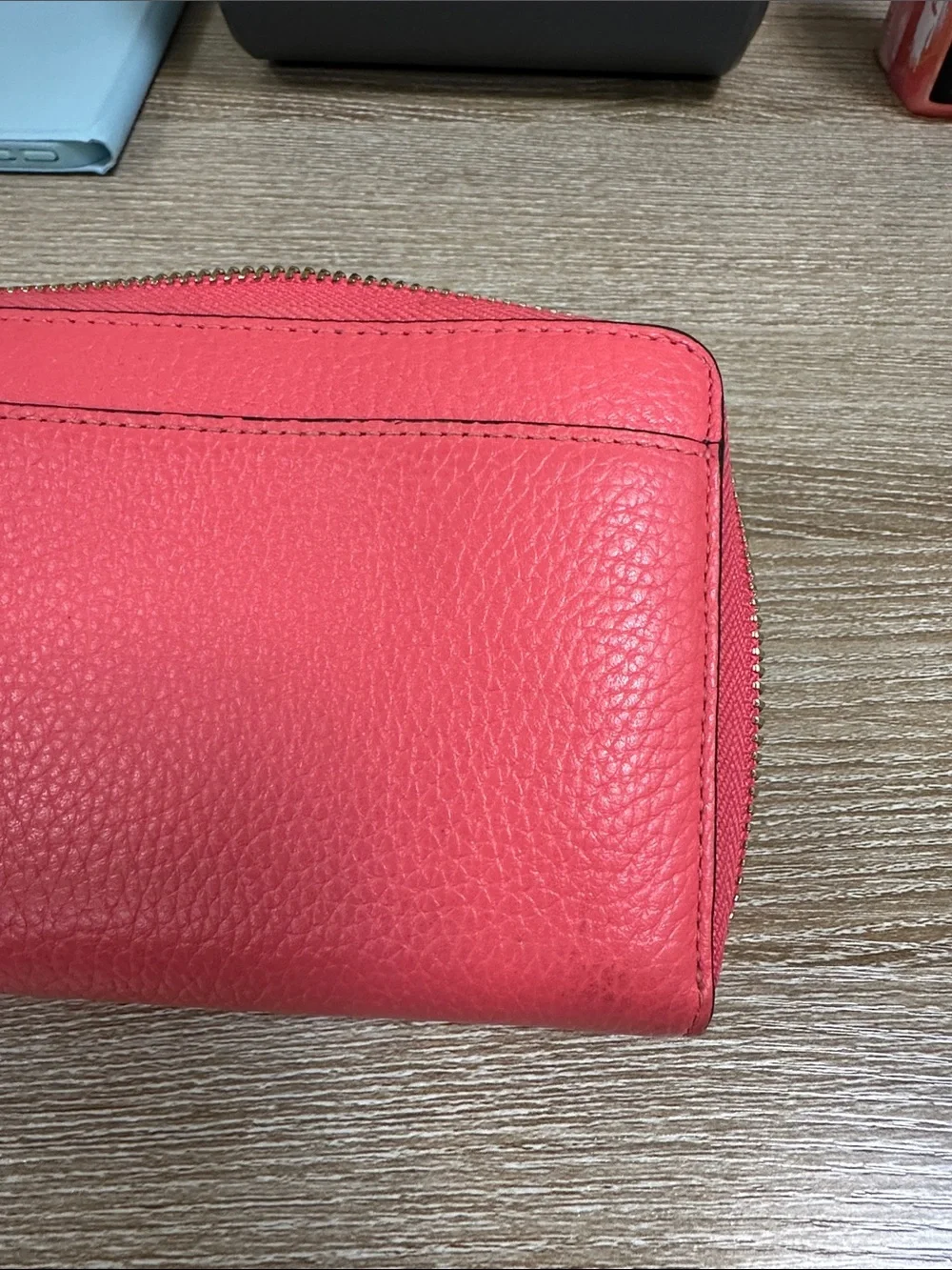 kate spade coral pink zip-around pebble leather wallet with wrist strap